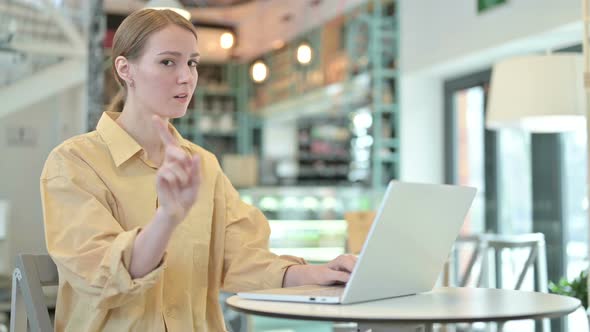 No, Finger Gesture By Young Woman with Laptop in Cafe 