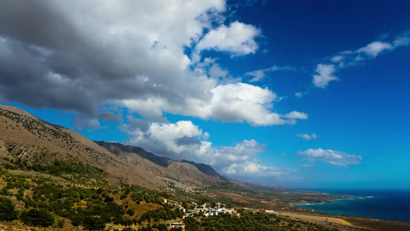 Time Lapse: Mediterranean Sea. White Fluffy Clouds Moving over Hills.