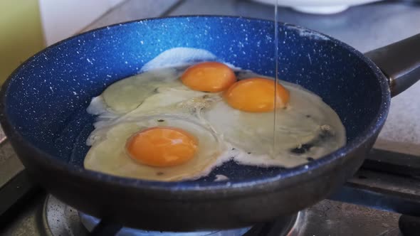 Home Breakfast. Fried Eggs Are Cooked in a Pan in the Home Kitchen