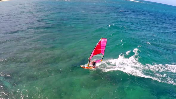 Aerial view of a man windsurfing in Hawaii