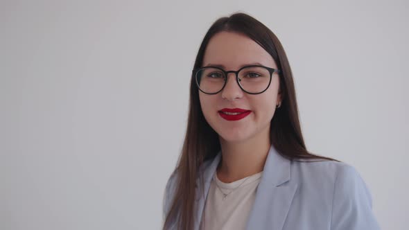 Spectacular Young Business Woman in Black Glasses Sends an Air Kiss