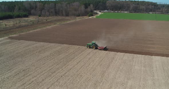 Tractor Cultivating Field. Agriculture and Machinery Aerial View