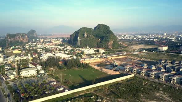 Aerial View Large Morning City Against Hill with Temple