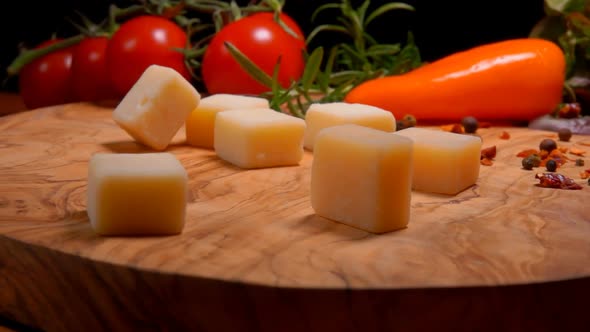 Hard Cheese Cubes Are Falling and Bouncing on a Wooden Board