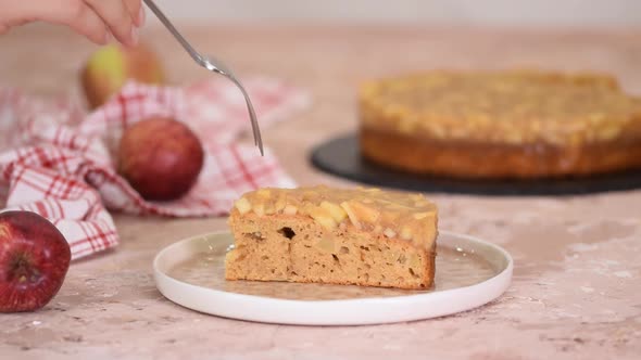 Piece of Apple Pie or Homemade Cake with Apples on Table