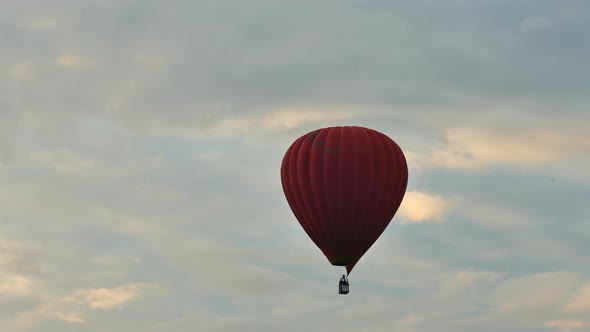 Hot air balloon before sunrise in the sky