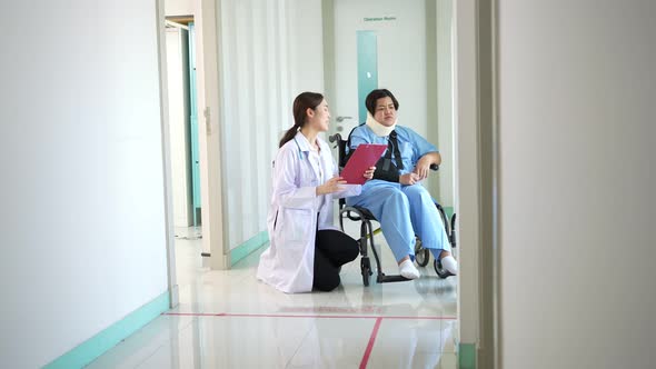 Asian woman patient in wheelchair after accident and talking with Doctor, Physiotherapist explain to