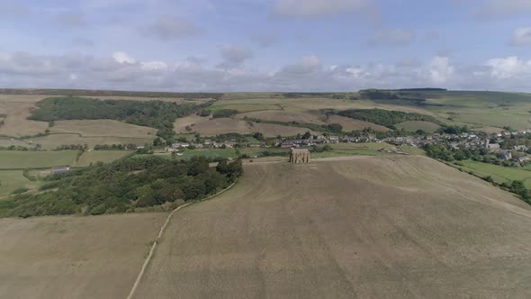 Forward tracking aerial high above the dorset coast heading towards the Chapel of St Catherine's nea