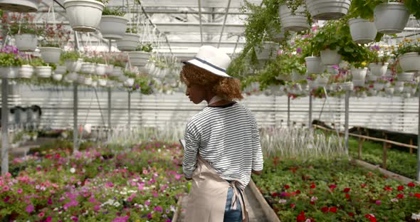 Black Race Female Florist with Notepad at Green House