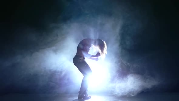 Muscles Man Silhouette of a Young Man Dancer. Slow Motion, Smoke