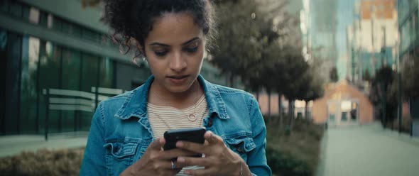 Video of Brazilian woman with phone waving to someone. Shot with RED helium camera in 8K.