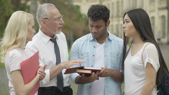 Experienced teacher talking with students about future scientific research