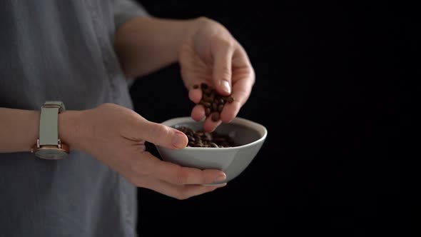 Anonymous woman with coffee beans