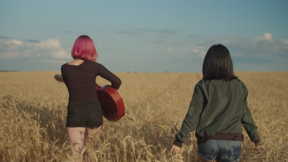 Carefree Multiracial Females Relaxing in Wheat Field