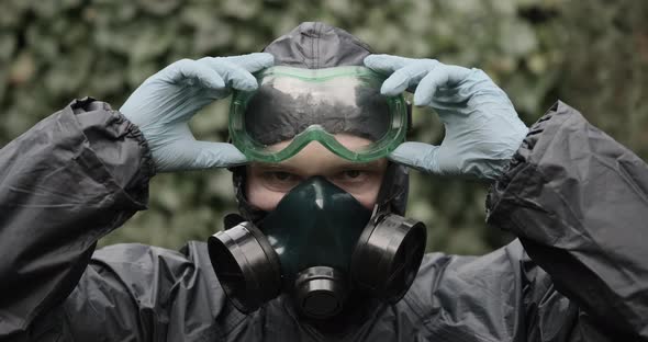 Man in Chemical Protection Suit Respirator and Glasses Closeup