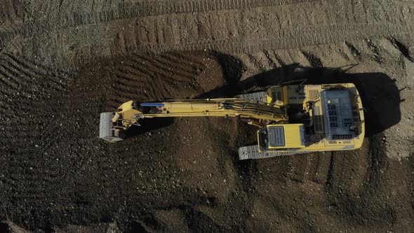 Aerial view of the excavator. The work of the excavator. Digger from the air.