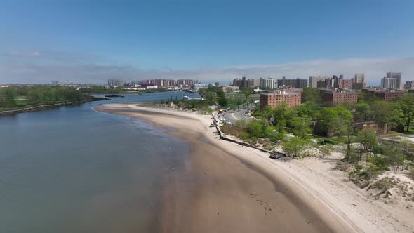 An aerial view over the beach on Gravesend Bay in Brooklyn, NY on a beautiful day with blue skies an