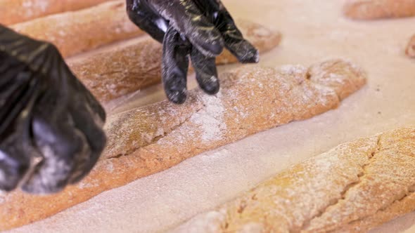 Baker Doing Knife-cutting Baguettes