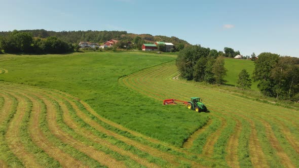 Agricultural Tractor Working On Fields Cutting Grass For Silage In Hjelmeland, Rogaland, Norway. Aer