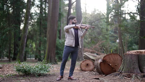 Nature and Music Musician is Playing Violin in Forest Amazing Fulllength Shot with Musician