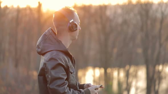 Man Listens To Music Near Lake