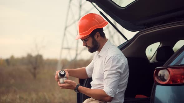 Technician With White Helmet Relaxing After Hard Job. Investor Engineer With Hardhat Drinking Tea.