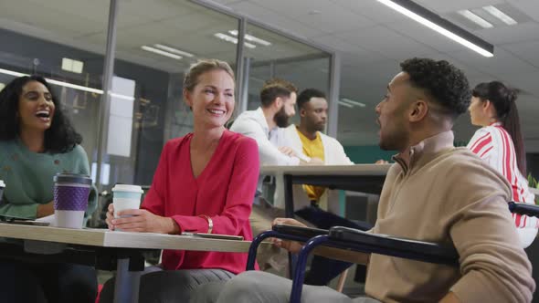 Happy diverse male and female business colleagues working in office