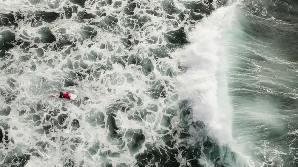 Lone Surfer Struggling Rowing Into the Waves