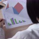 A Businesswoman Analyzing A Colorful Fluctuating Bar Graph On Desk In Office - VideoHive Item for Sale