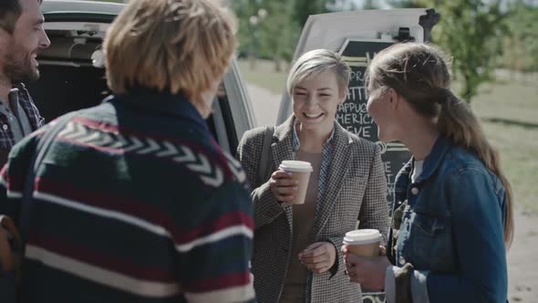 Friends Enjoying Coffee Outside and Chatting