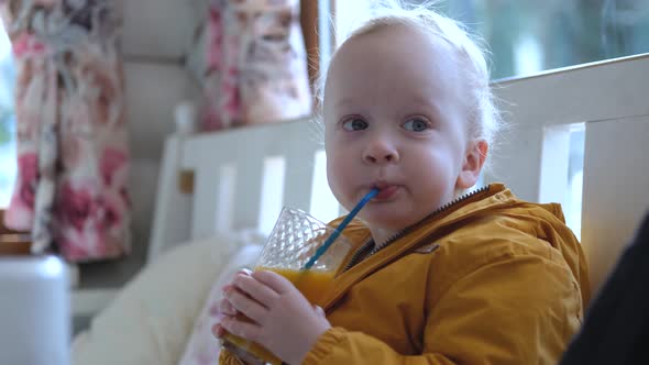 little boy drinking orange juice