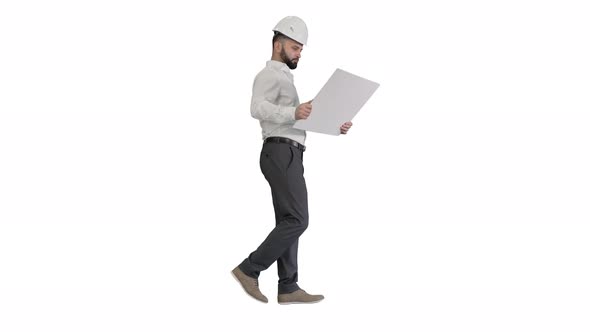 Young Construction Architect Walking Looking at Blueprint on White Background.