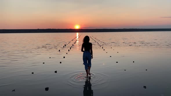 Free happy woman dancing and enjoying the sunset view.