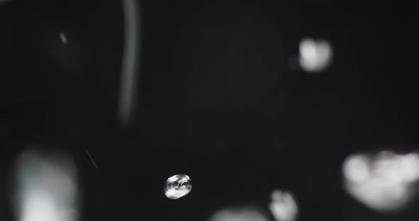 Water Poured Into Liquid Creating Rising Bubbles