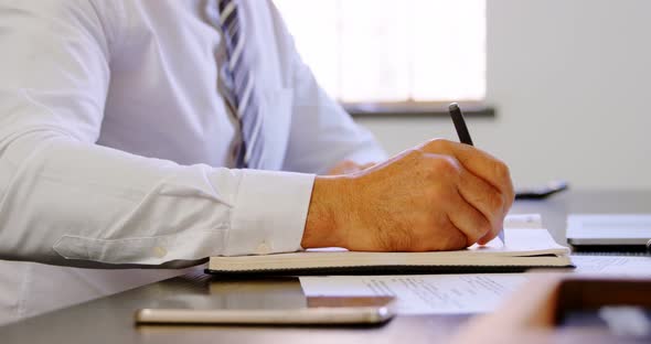 Executive working on his desk in office 