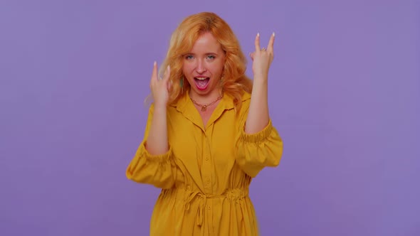 Overjoyed Redhead Girl Showing Rock n Roll Gesture By Hands Cool Sign Shouting Yeah with Crazy Face