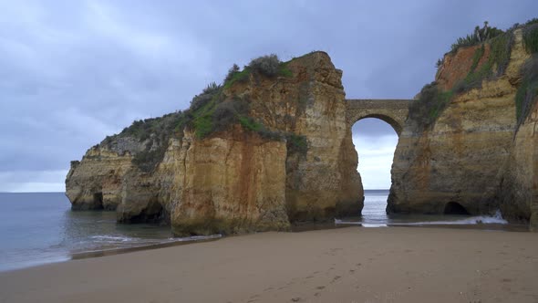 Praia dos estudantes beach with arch bridge in Lagos, Portugal