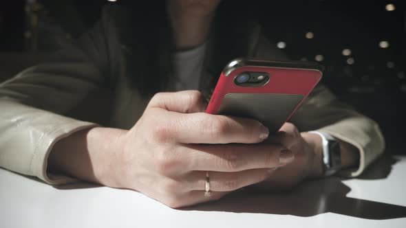 Girl in a Cafe Works on the Phone, Keep Your Smartphone in Your Hands