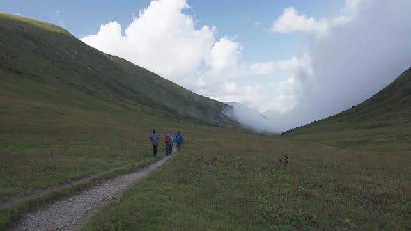 Bzerpinskiy Karniz, a Group of Hikers Walking Down a Mountain Trail