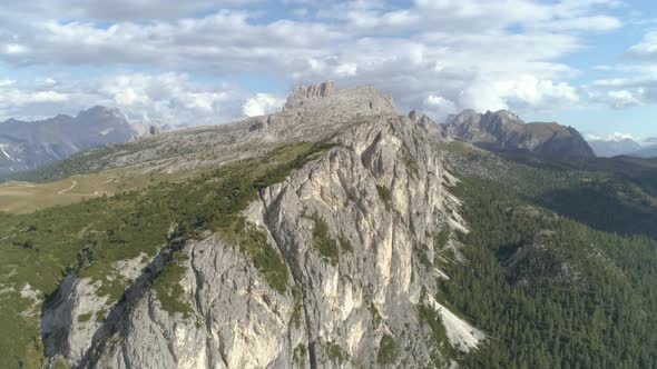 Aerial Wide of the Italian Dolomites Rocks covered with Trees during Sunset