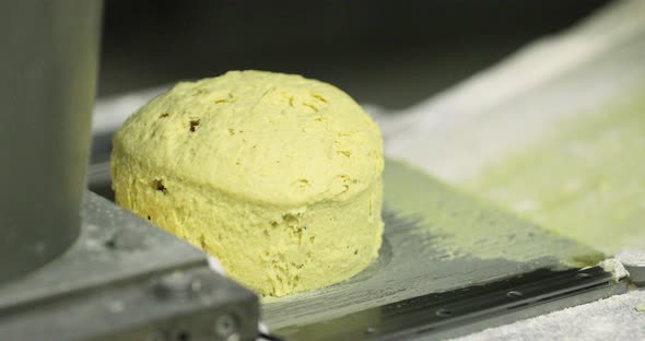 Bread Dough Moulder And Divider Machine In A Bakery - close up, slow motion