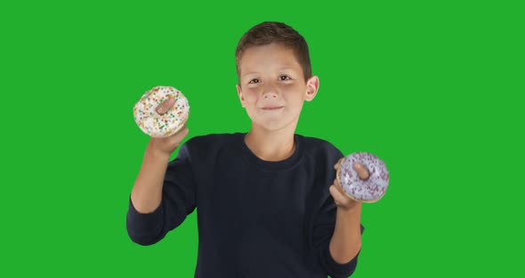 Closeup. Portrait of a Funny Guy, Having Fun with Colorful Donuts Against His Face