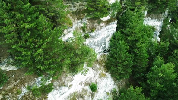 Beautiful view from height of the flight on mountains covered with pine trees, helicopter shooting