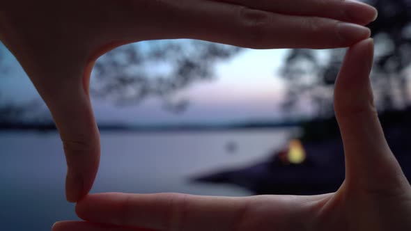 A Bonfire Burning in a Forest on the Shore of a Lake at Midnight