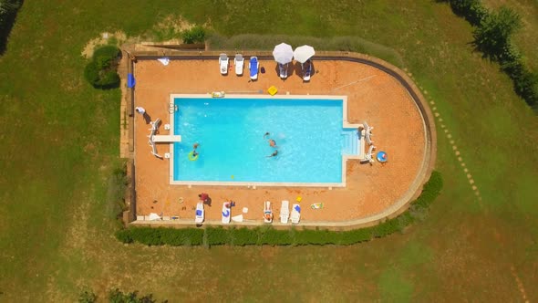 Birds-eye View of People Swimming in Pool