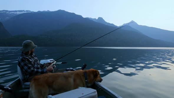 Fisherman fishing with his dog in the river 4k