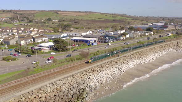 Commuter Train Alongside the Sea on a Sunny Day