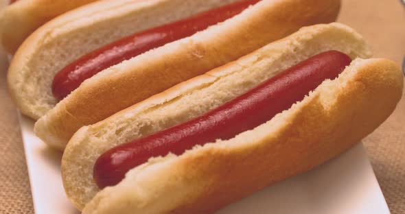 Delicious hot dogs with a selection of condiments on the side.