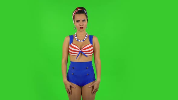 Beautiful Girl in a Swimsuit Is Threatening and Shaking Her Index Finger. Green Screen