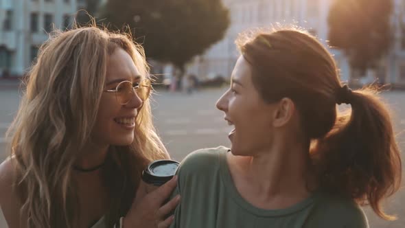 Two Best Friends Meet Together Outdoors at Beautiful Summer Day in Golden Sunset Hour. Unexpected